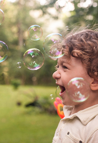 baby is playing with bubbles