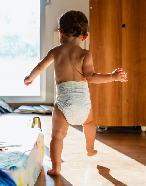 baby walking in diapers