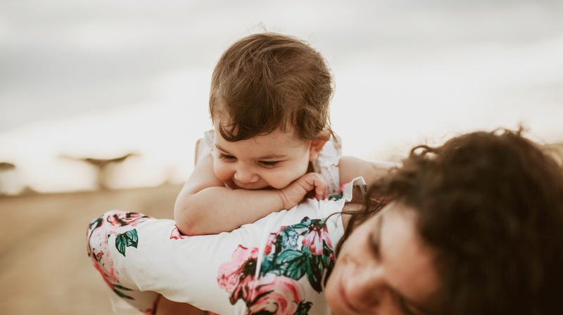 happy baby riding on mom's back